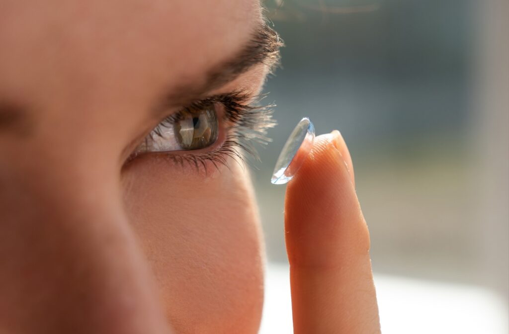 Someone putting a contact lens in their eye.