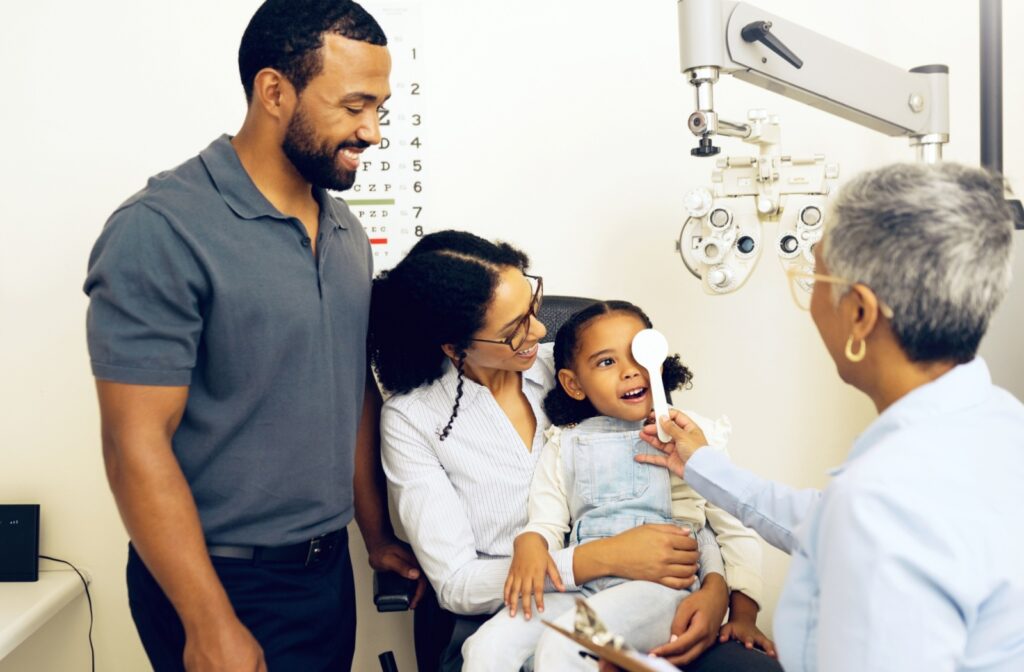 A child getting their eyes checked by an optometrist.